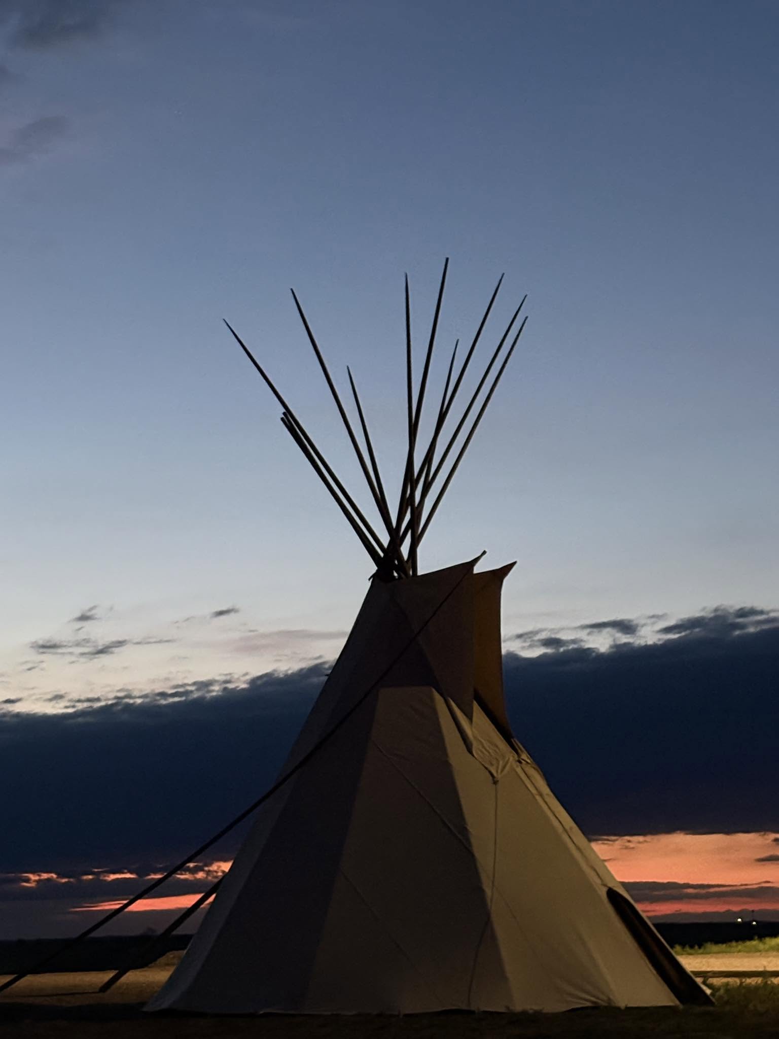 A tipi against the dusk sky at Pine Ridge